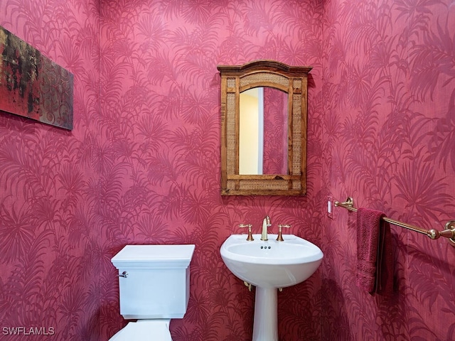 455 Cove Tower Dr Unit 1704, Naples, FL 34110 - half bathroom featuring wallpapered walls and toilet