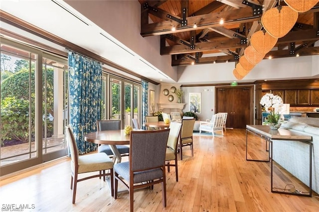455 Cove Tower Dr Unit 1704, Naples, FL 34110 - dining space featuring a high ceiling, healthy amount of natural light, and light wood finished floors