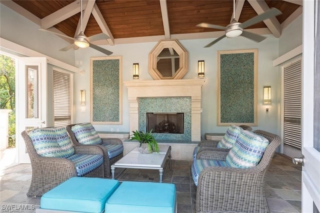 455 Cove Tower Dr Unit 1704, Naples, FL 34110 - living area featuring a ceiling fan, wood ceiling with exposed beams, and a fireplace
