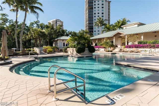 455 Cove Tower Dr Unit 1704, Naples, FL 34110 - community pool featuring a patio