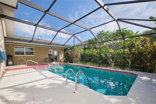 view of swimming pool with a patio area and glass enclosure