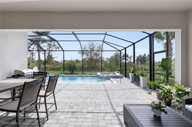 view of pool with glass enclosure and a patio area