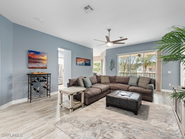 living room with ceiling fan and light hardwood / wood-style floors