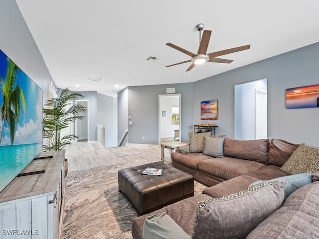 living room with hardwood / wood-style flooring and ceiling fan