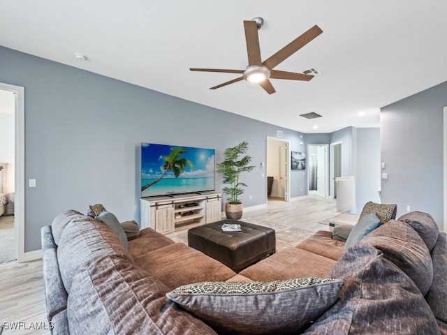 living room with light wood-type flooring and ceiling fan