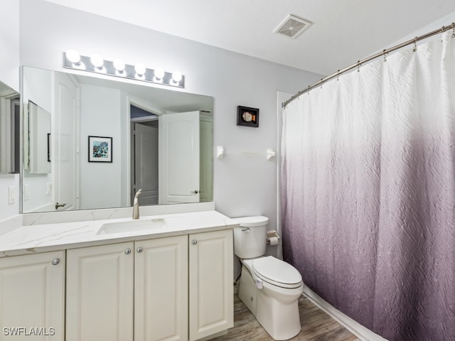 bathroom with vanity, curtained shower, toilet, and wood-type flooring