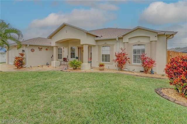 ranch-style home featuring a garage and a front yard