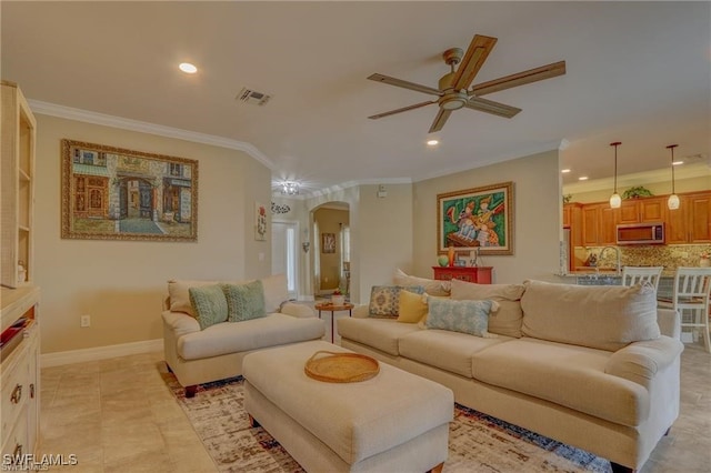 living room with ceiling fan, light tile patterned flooring, and crown molding