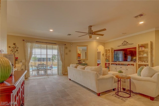 living room featuring ornamental molding and ceiling fan