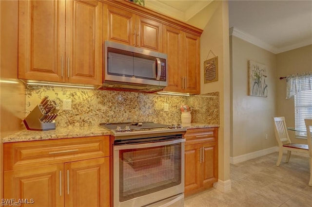 kitchen featuring tasteful backsplash, light stone countertops, light tile patterned floors, stainless steel appliances, and crown molding