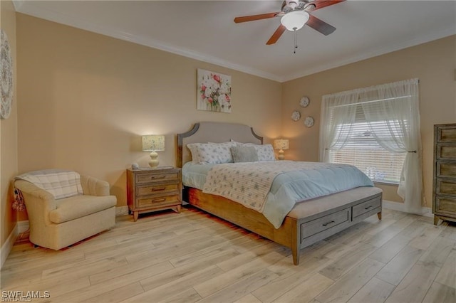 bedroom featuring ornamental molding, light hardwood / wood-style floors, and ceiling fan