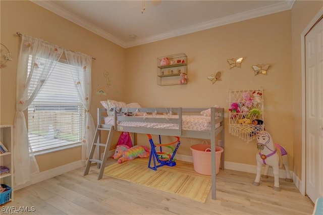 bedroom with ornamental molding and hardwood / wood-style floors