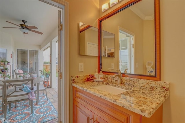 bathroom featuring ceiling fan, vanity, and crown molding