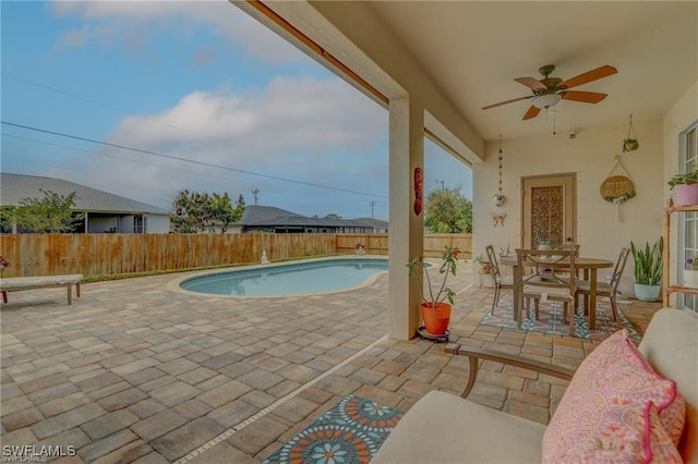 view of pool featuring a patio and ceiling fan