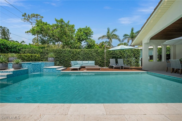 view of pool featuring a patio, an outdoor living space, and pool water feature