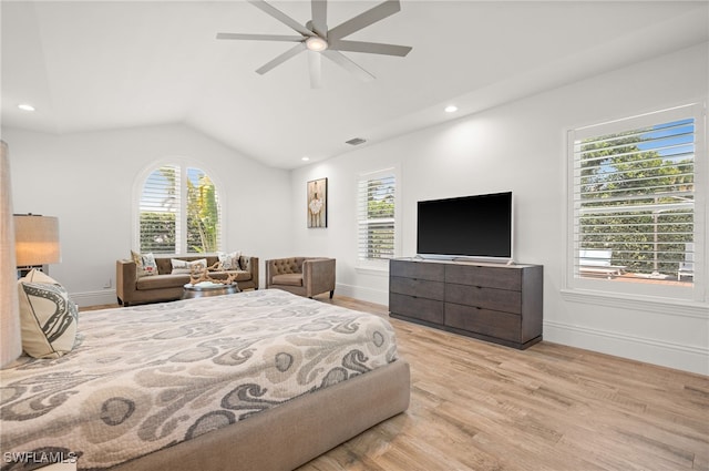 bedroom featuring lofted ceiling, multiple windows, ceiling fan, and light hardwood / wood-style floors