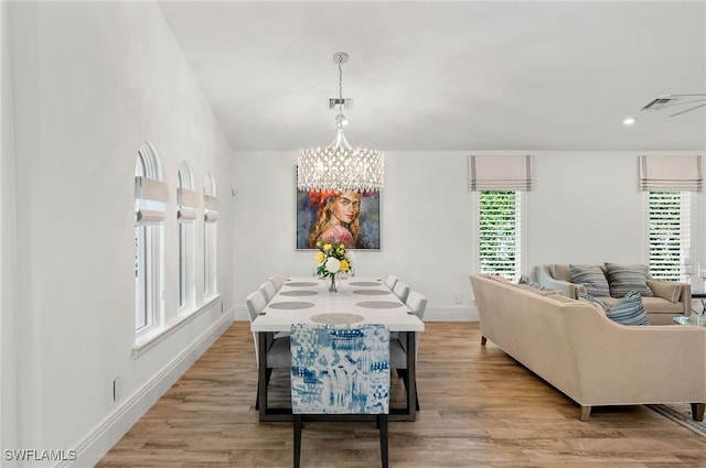 dining area featuring an inviting chandelier and light wood-type flooring