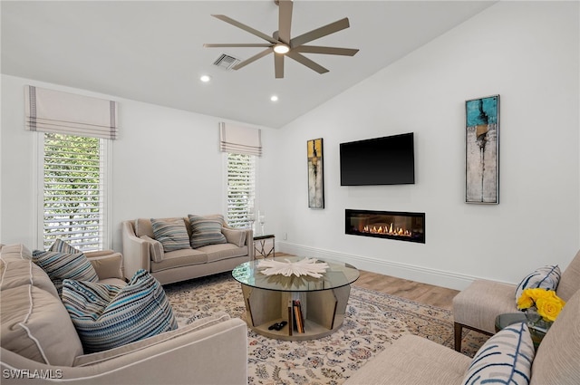 living room featuring lofted ceiling, ceiling fan, and hardwood / wood-style floors