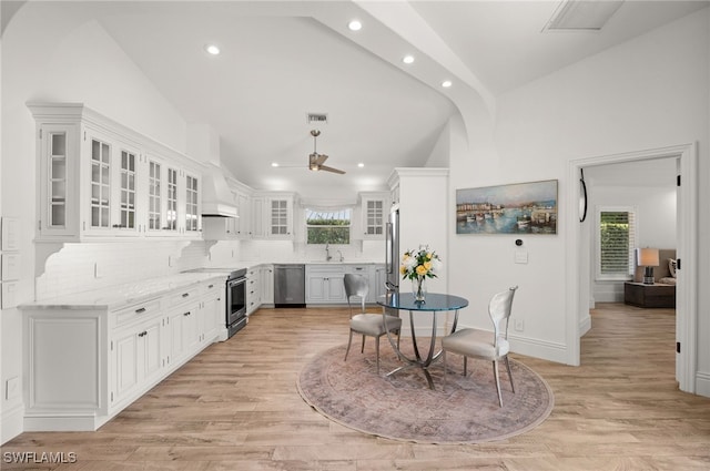 kitchen featuring light wood-type flooring, ceiling fan, white cabinetry, and stainless steel appliances