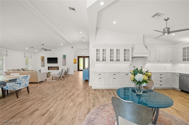 living room with ceiling fan, vaulted ceiling with beams, and light hardwood / wood-style flooring