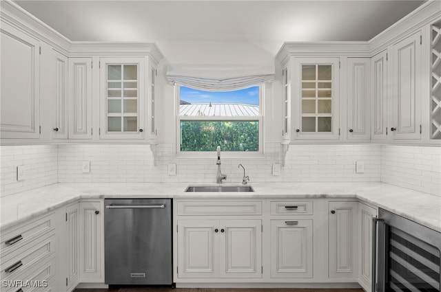 kitchen featuring tasteful backsplash, beverage cooler, sink, white cabinets, and stainless steel dishwasher