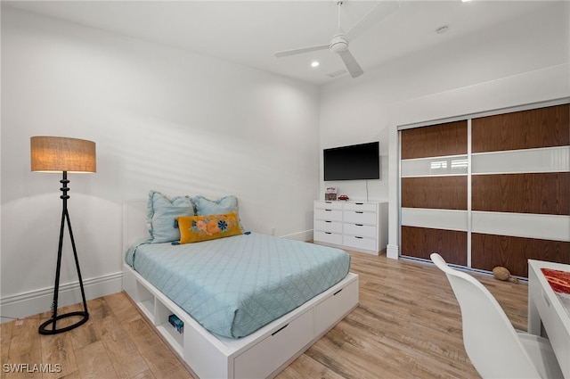 bedroom featuring light hardwood / wood-style flooring and ceiling fan