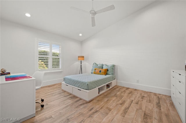 bedroom with ceiling fan, vaulted ceiling, and light hardwood / wood-style flooring