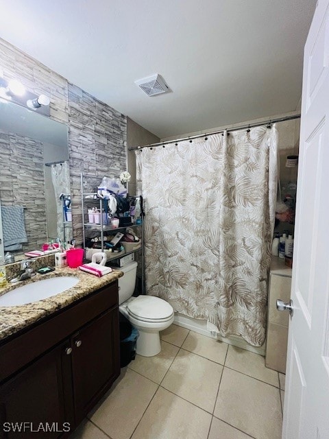 bathroom featuring vanity, curtained shower, toilet, and tile patterned flooring