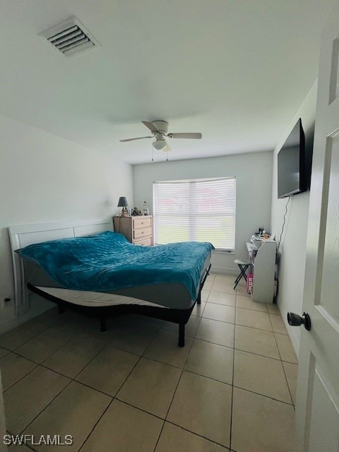 tiled bedroom with ceiling fan