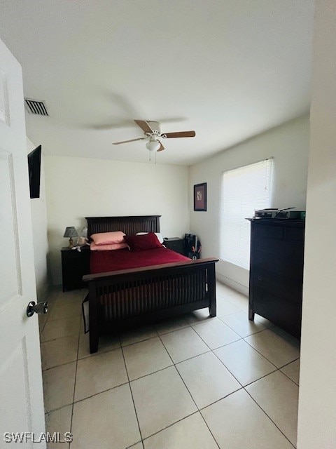 bedroom featuring light tile patterned floors and ceiling fan