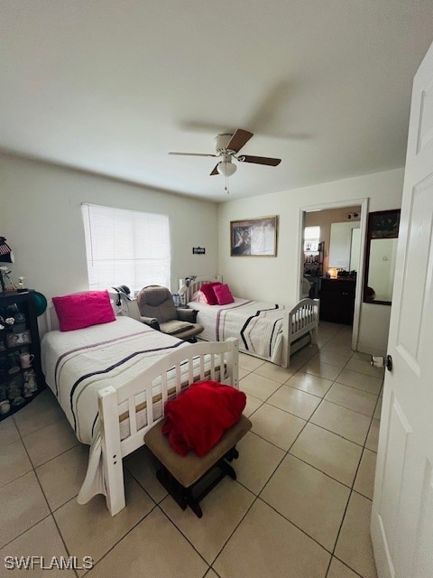 bedroom with light tile patterned flooring and ceiling fan