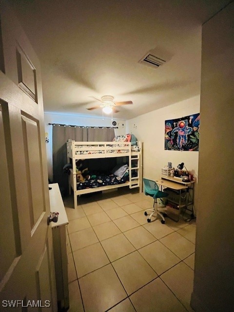 tiled bedroom with ceiling fan