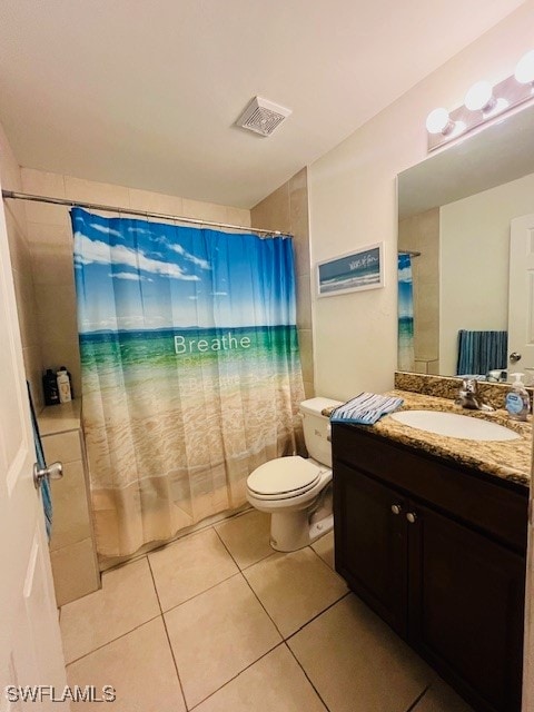 bathroom featuring toilet, curtained shower, vanity, and tile patterned floors