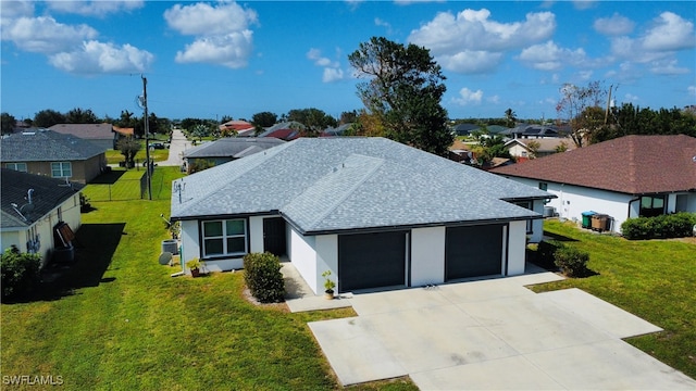 ranch-style house featuring a front lawn and a garage