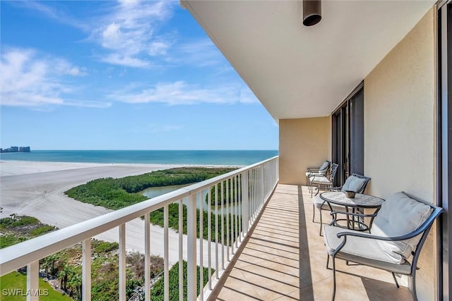 balcony with a beach view and a water view