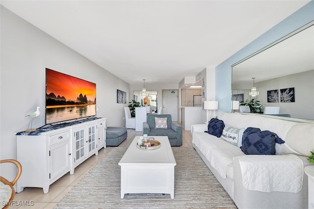 living room featuring light tile patterned floors and an inviting chandelier