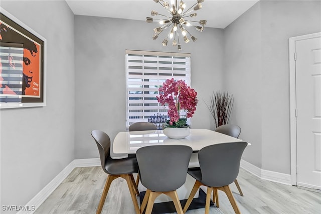 dining space with an inviting chandelier and light wood-type flooring