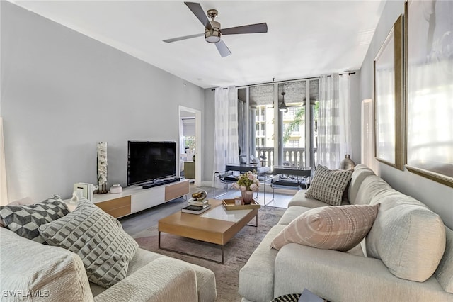 living room with wood-type flooring and ceiling fan