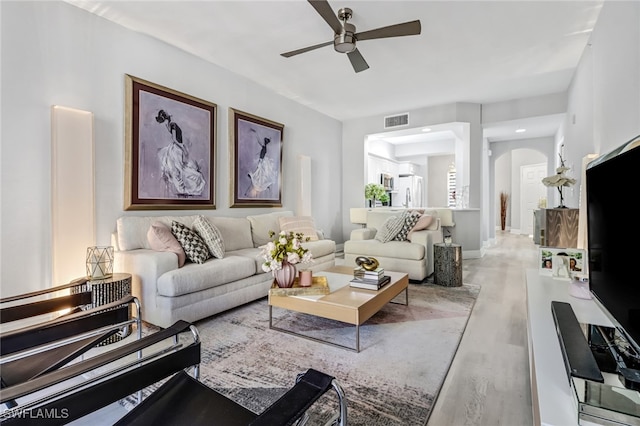 living room with ceiling fan and light hardwood / wood-style floors