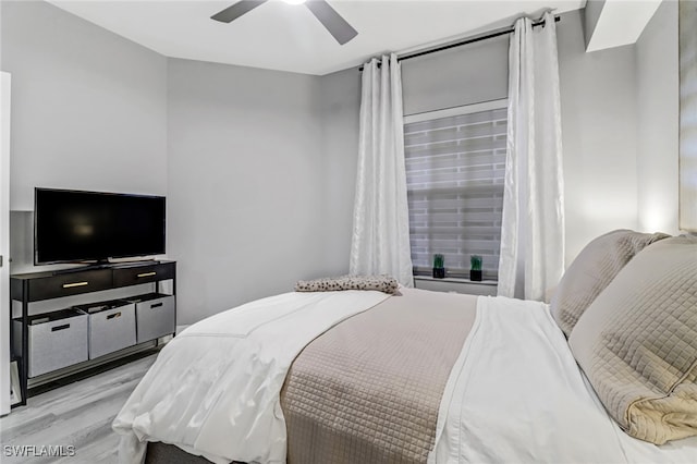 bedroom with ceiling fan and light wood-type flooring