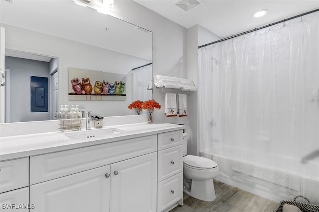 full bathroom featuring hardwood / wood-style floors, vanity, toilet, and shower / bathtub combination with curtain