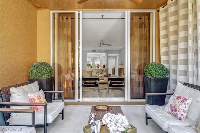 interior space featuring concrete floors and ceiling fan