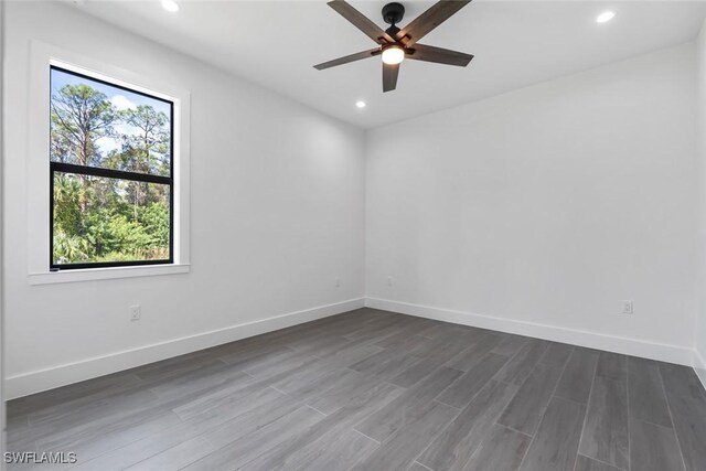 unfurnished room featuring ceiling fan, plenty of natural light, and hardwood / wood-style floors