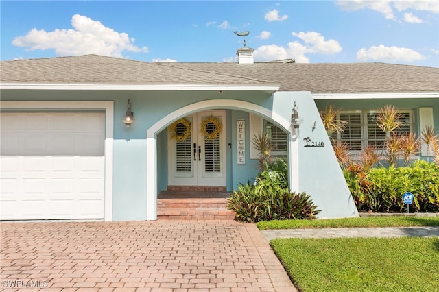 doorway to property with a garage