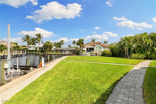 view of yard with a dock and a water view