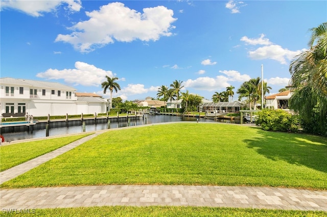 view of yard with a boat dock and a water view