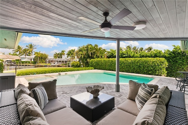 view of swimming pool with outdoor lounge area, ceiling fan, and a patio