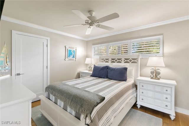 bedroom featuring ceiling fan, dark hardwood / wood-style flooring, and ornamental molding