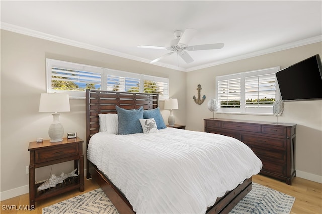 bedroom with multiple windows, ceiling fan, crown molding, and light hardwood / wood-style floors