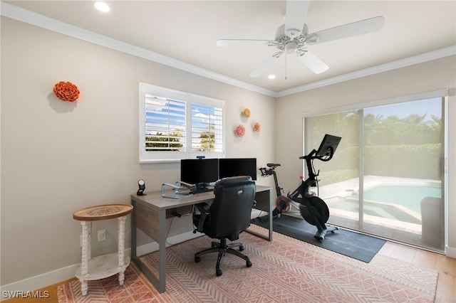 office area with light wood-type flooring, ceiling fan, and crown molding